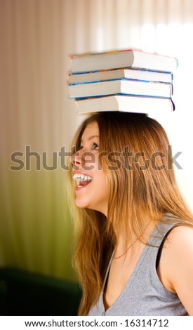 Beautiful young female student carrying books 3