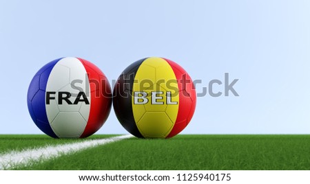 France vs. Belgium Soccer Match - Soccer balls in France and Belgium national colors on a soccer field. Copy space on the right side - 3D Rendering