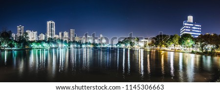 Panoramic photo of the Lago Igapo, Londrina - Parana, Brazil. View of the Igapo lake at night and the city, buildings on background. Leisure place, touristic destination of the city.