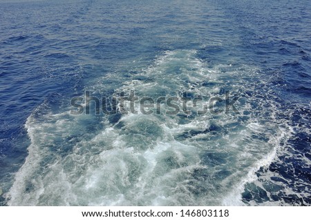 Sea water in the wake of the ship foaming formation and rages