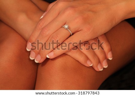 Beautiful hands modeling a solitaire diamond engagement ring