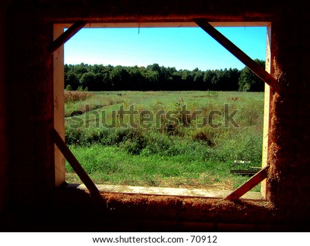 a field framed by a window that\'s under construction