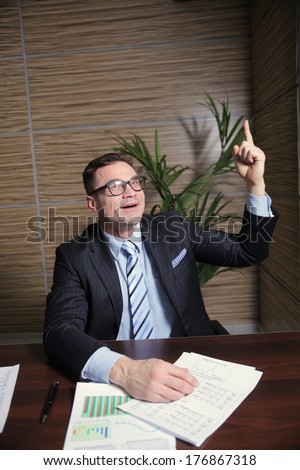 businessman happily raised his hand above his head, a symbol of the decision, found ideas