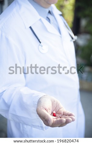 the doctor with pill in his hand