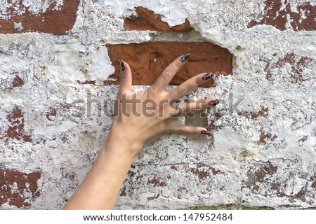 hand pressed against the brick wall women palm fingers manicure ring gold nails red brown white