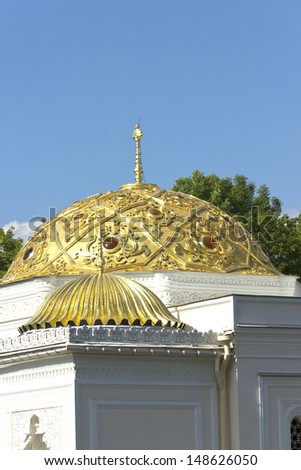 Turkish bath on the lake shore in the Catherine Park sky clouds gold dome water