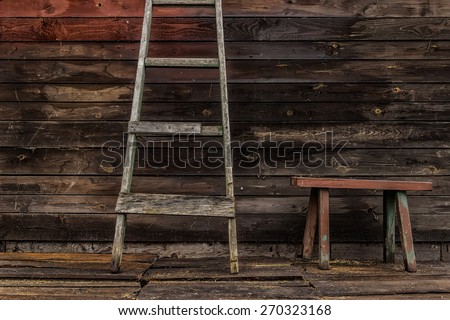 Old wooden bench ladder against the wall