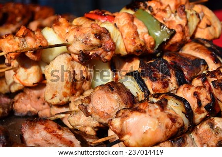 Skewers on wooden sticks tasty pork meat and vegetables mix