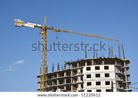 Building yard with construction crane on a blue sky