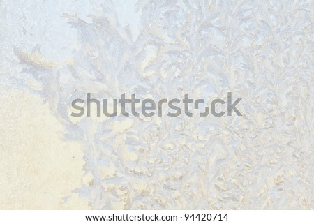 Natural ice crystals pattern background on a window glass