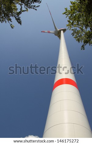 Wind generator vertical with red stripe and blue sky