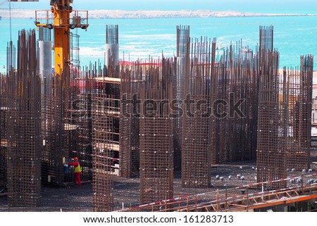 Construction site with worker in Dubai at the seaside
