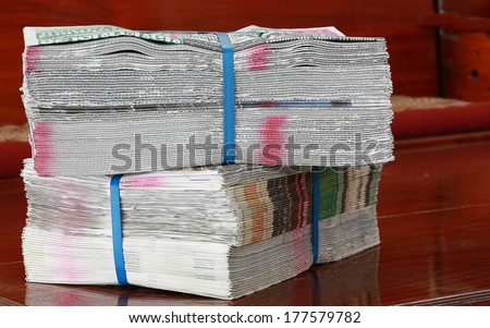 pack of  newspapers on table wood