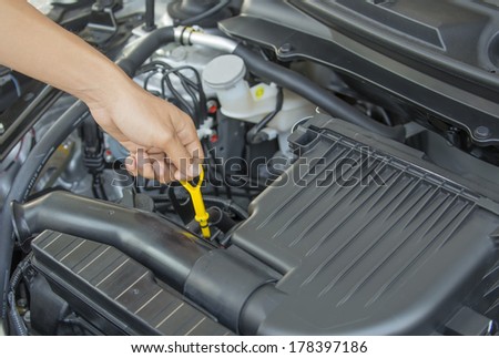 Automobile Maintenance - Pulling the Engine Dipstick to Check the Oil Level