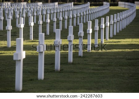 NETTUNO, ITALY - MARCH 23, 2014: American War Cemetery. A field of headstones of 7,861 of American military war dead is arranged in gentle arcs on broad green lawns to commemorate the sacrifice.