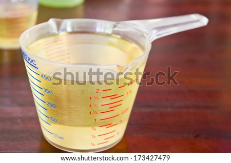 oil in measuring cup on table in kitchen