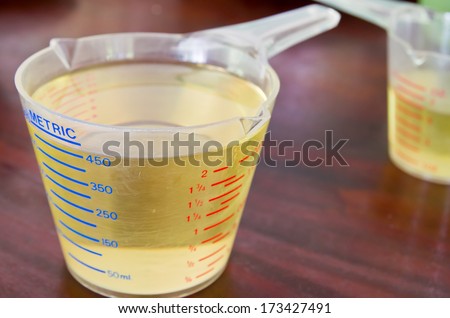 oil in measuring cup on table in kitchen