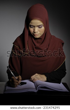 Muslim Woman In Hijab Reading