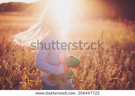Little Blonde Girl Twirling in the Sunset
