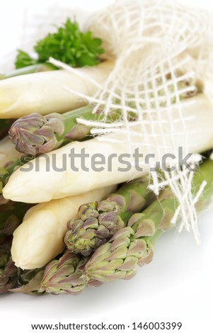 Green and white asparagus on white background