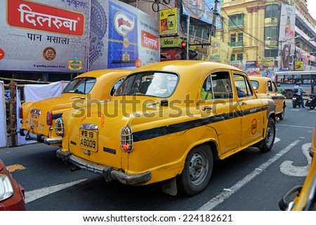 KOLKATA (CALCUTTA), WEST BENGAL, INDIA - OCTOBER 02, 2014: Two Yellow taxis abreast. Ambassador, modeled after the British Morris Oxford, was the first car to be made in India.