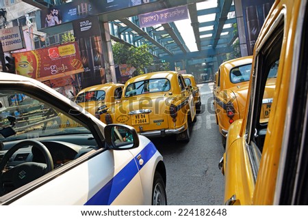 KOLKATA (CALCUTTA), WEST BENGAL, INDIA - OCTOBER 02, 2014: Fleet of yellow taxis. Ambassador, modeled after the British Morris Oxford, was the first car to be made in India.