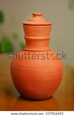 Vintage earthen pot (Kooja) of Kerala, India for storing water. Due to capillary action and subsequent evaporation from the surface, the water inside becomes cold.
