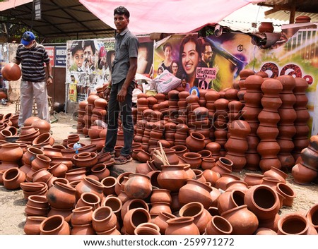 TRIVANDRUM, KERALA, INDIA, MARCH 04, 2015: Preparations for the final ceremony of the Attukal temple, the largest congregation of women in the world. A boy sells pots in the morning by the roadside.