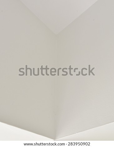 Walls, corners and edges. Faces of walls meet at right angles to form interesting abstract designs.Triangles, parallelograms. High key image. Converging walls, converging lines.