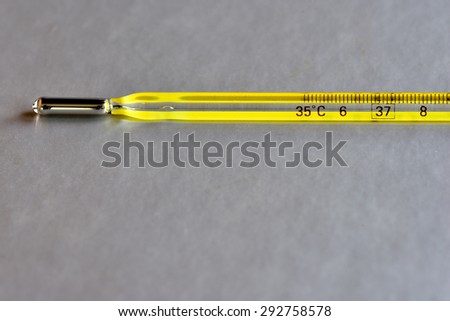 Clinical thermometer to measure body temperature, isolated on grey background.