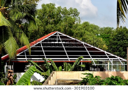 Construction of aluminium roof on the terrace of a house in Trivandrum. Geometric lines, shapes and patterns.