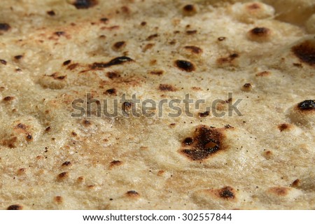 Closeup of cooked chapati showing burnt blisters - India's favorite food.