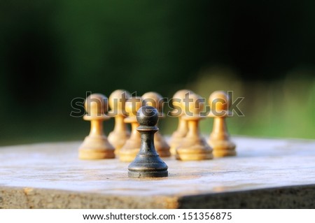 Chess pawns in a board representing isolation