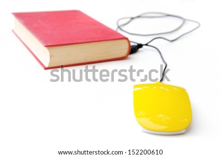 Conceptual photo with old book and computer mouse