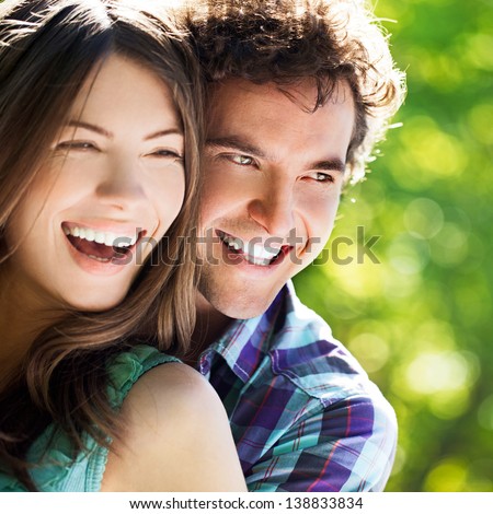 Young Happy Couple Hugging And Laughing.
