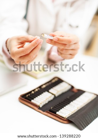 Homeopathist with a selection of homeopathic pills.