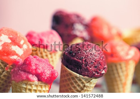 Fruit ice-cream in ice-cream cones.