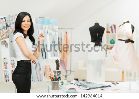 A fashion designer sorting out her new sketches.