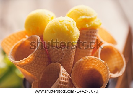 Delicious lemon ice-cream served in ice-cream cones.
