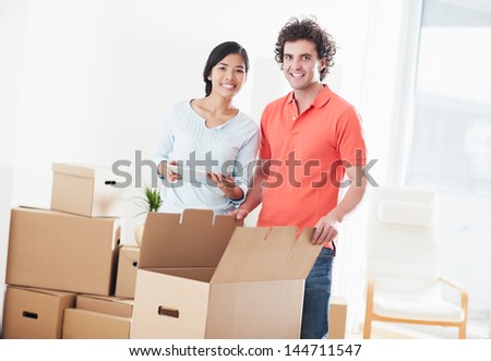 Young multi-ethnic couple moving into their new home.