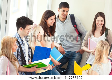 Group of university students talking during the break between classes.