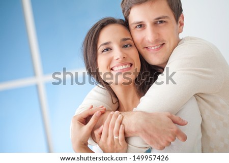 Happy Young Couple In Their Modern Living Room.