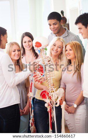 Skilled teacher teaching anatomy to young college students.