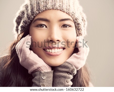 Portrait of a young Asian woman dressed in warm winter clothes.