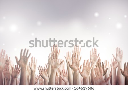 Many people\'s hands up.