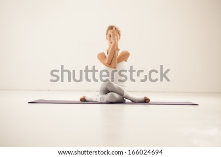 Studio Shot Of A Young Fit Woman Doing Yoga Exercises.