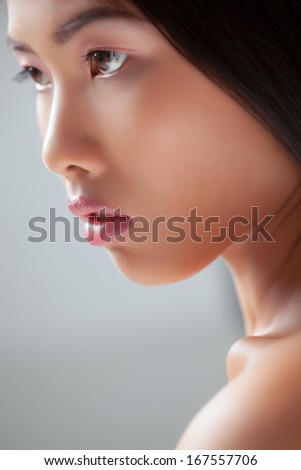 Indoor beautu portrait of a sensual young Asian woman.