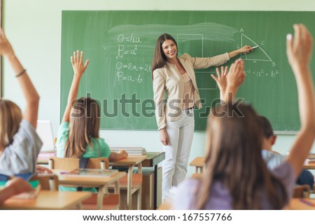 Students answering the teacher\'s question in a maths lesson.