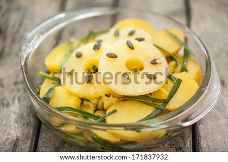 Pineapple salad with pumpin seeds and leek.