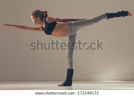 Woman balancing while doing yoga.